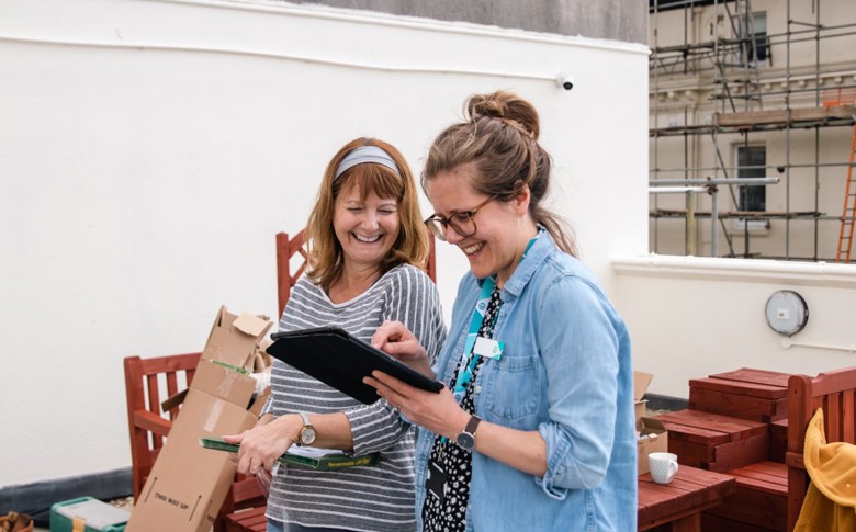 image: a Southern Housing colleague talking to a resident about support available to them