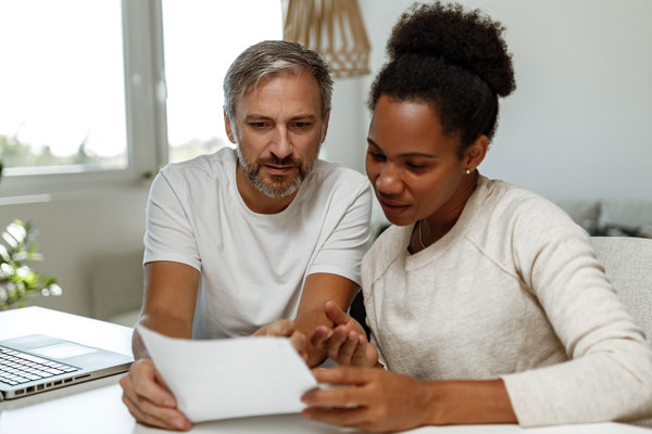 A couple look at a piece of paper 