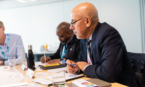 Puneet Rajput, Director of Governance and Regulation, takes part in a resident Board meeting