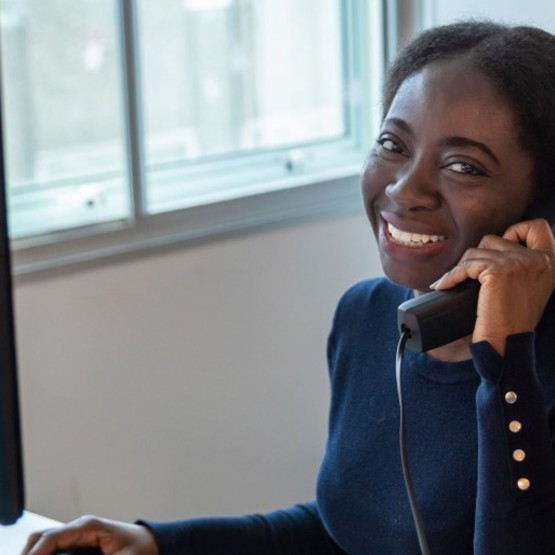 image: a member of the Southern Housing customer services team answering the phone