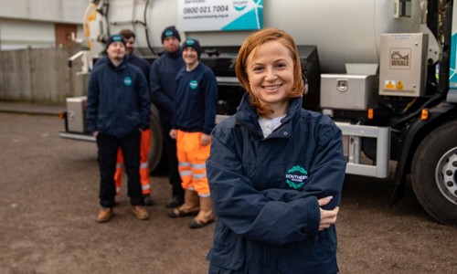 image: Southern Housing team members smiling wearing their uniforms when out at work