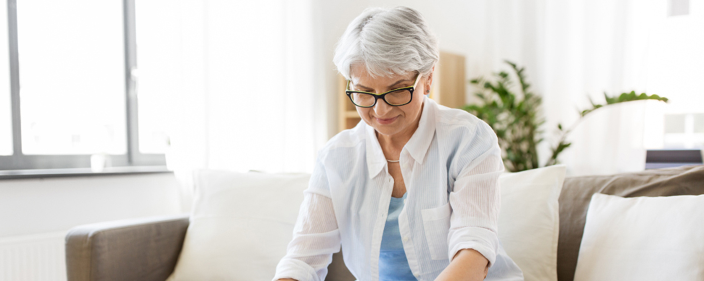 Older woman uses a calculator 