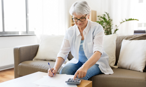 Older woman uses a calculator 